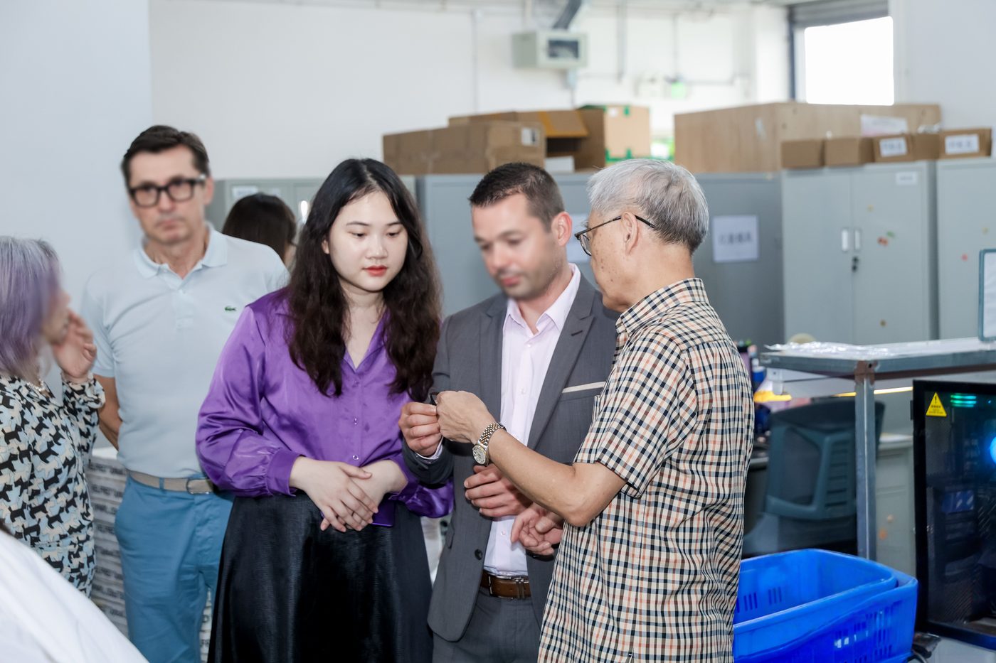 Topsure interpreter accompanying foreign clients during a factory visit in Shenzhen